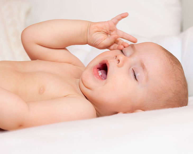 baby rubbing face while sleeping