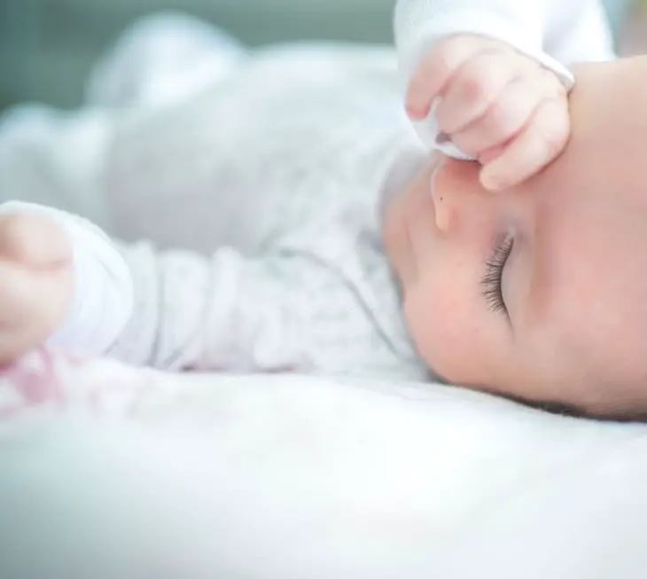 why do babies rub their face when sleeping